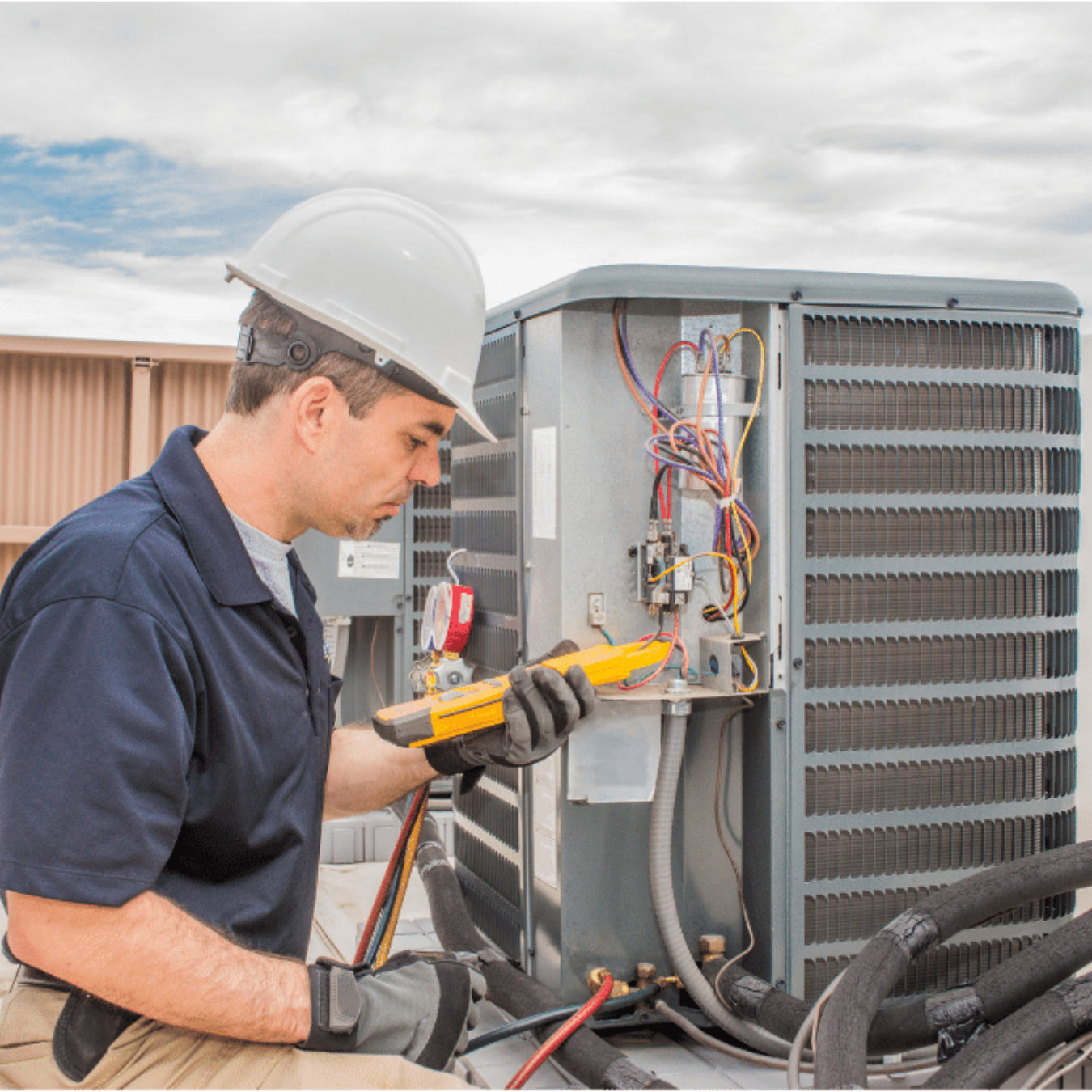 Wallaceburg Heating & Cooling HVAC technician servicing a system