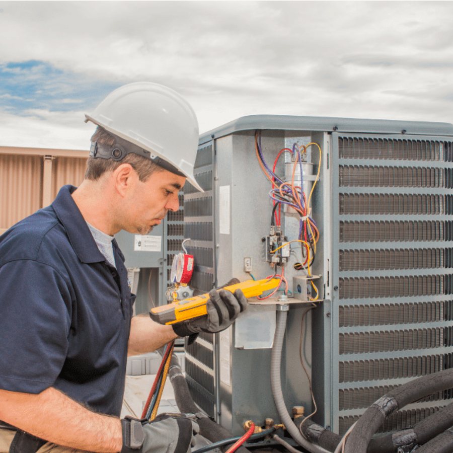 Wallaceburg Heating & Cooling HVAC technician servicing a system
